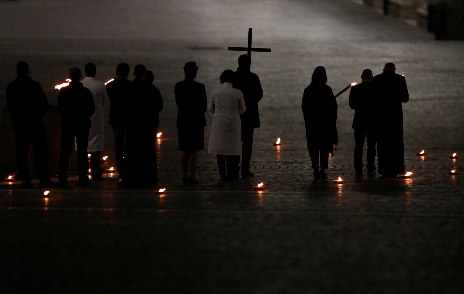 Health care and prison workers attend the Via Crucis procession led by Pope Francis in St. Peter’s Square at the Vatican April 10, 2020. The Good Friday service was held with no public participation because of the COVID-19 pandemic.